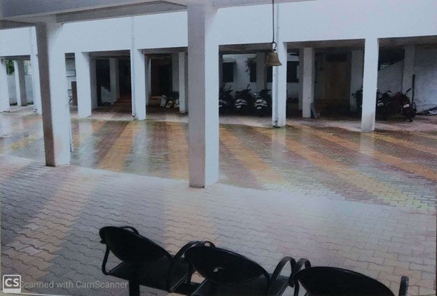 Organized parking area with designated spaces for cars and two-wheelers
